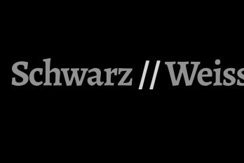 Die Schrift Schwarz//Weiss in grauer auf schwarzem Grund